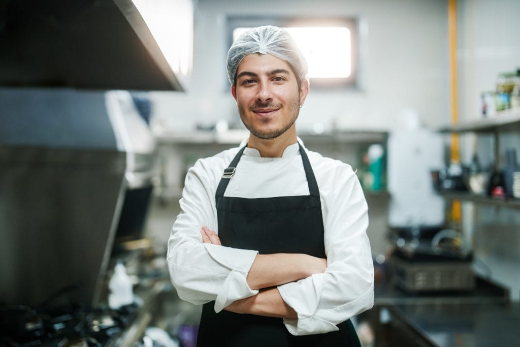 Portrait of a chef in restaurant kitchen.