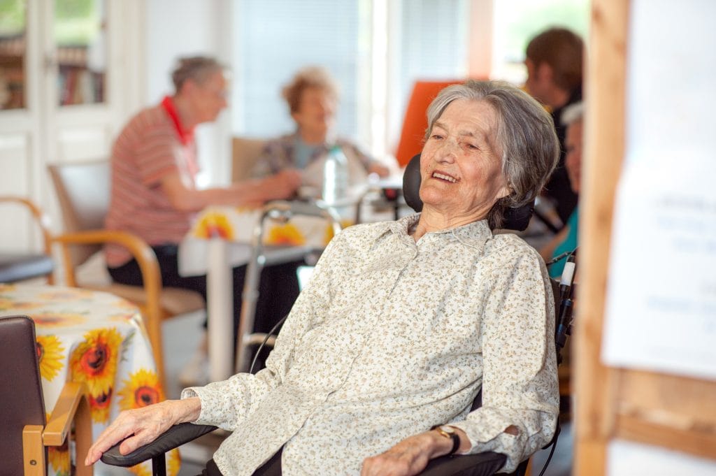 Portrait Of Smiling Senior Woman On Wheelchair