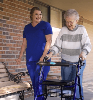 the-care-center-staff-and-resident-on-a-walk_315x338